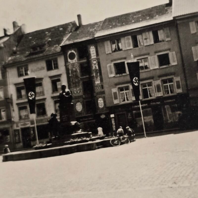 20260809_150737 WWII German Swastika Flag Town Square Monument Photo – Occupied City